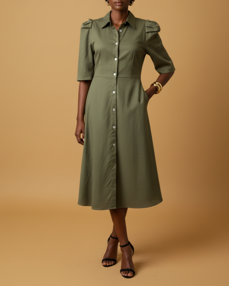 Woman wearing a green dress against a beige background