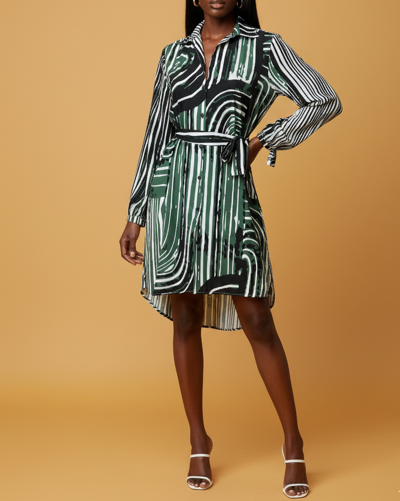 Front shot of a model wearing a green and white patterned shirt dress on a beige background. 